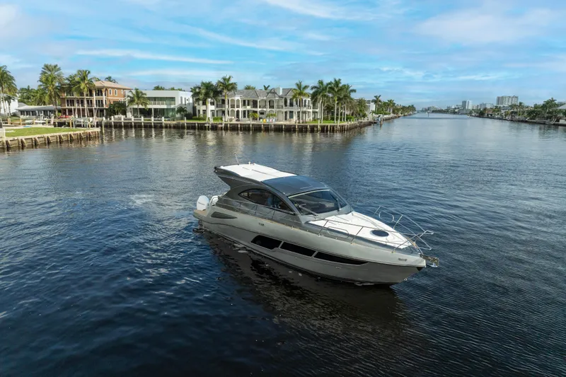 Slide: The Image of Luxurious 2025 Valiatt 410HT yacht cruising on a scenic waterfront with palm trees. - 6