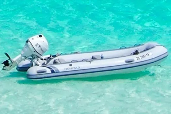 Slide: The Image of Inflatable boat with outboard motor on clear turquoise water, Leopard 48, 2015 model. - 100