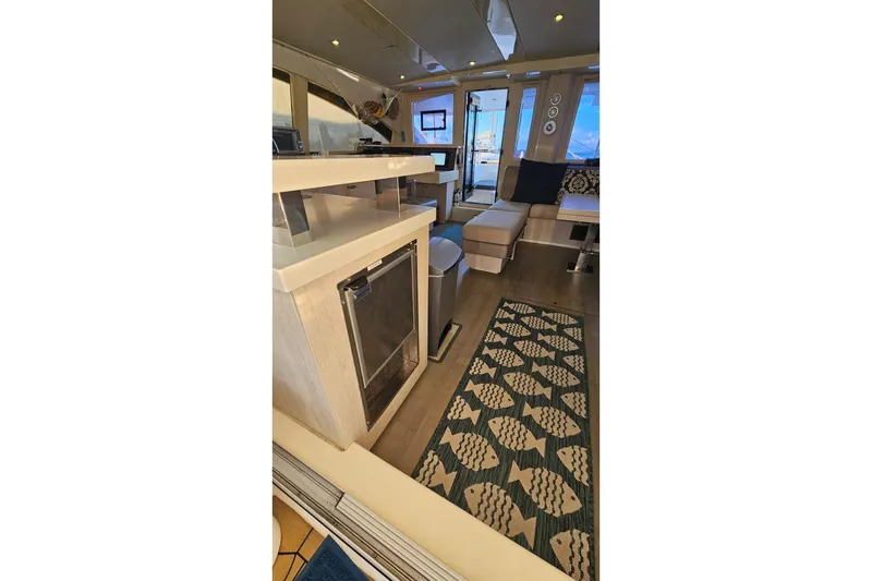 Slide: The Image of Luxurious interior of 2015 Leopard 48 yacht with modern furnishings and fish-patterned rug. - 14