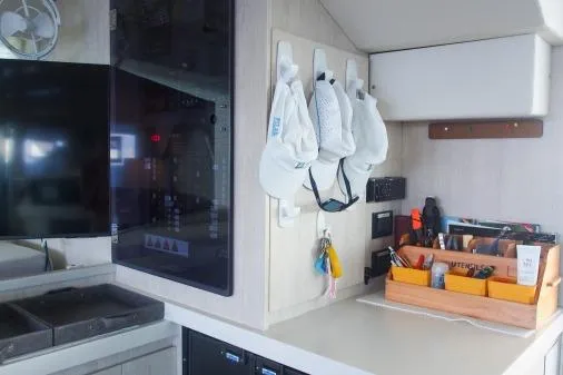 Slide: The Image of Interior of a 2015 Leopard 48 yacht with organized kitchen and storage area. - 23