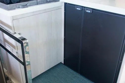 Slide: The Image of Modern kitchen area in a 2015 Leopard 48 yacht with sleek cabinetry. - 25