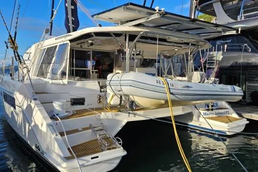 Slide: The Image of 2015 Leopard 48 yacht docked with inflatable boat, sunny day, marina setting. - 3
