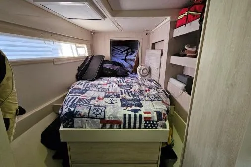 Slide: The Image of Cozy bedroom in 2015 Leopard 48 yacht with nautical-themed bedding and storage shelves. - 31