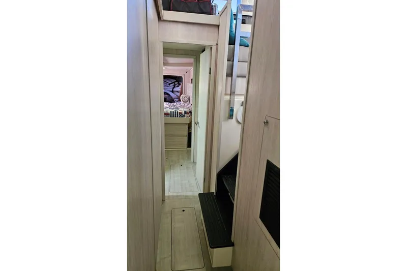 Slide: The Image of Narrow hallway inside 2015 Leopard 48 yacht, leading to a cozy bedroom. - 34