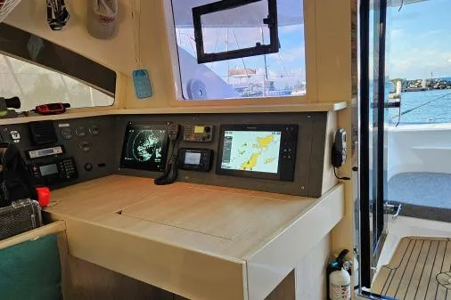 Slide: The Image of Leopard 48 yacht navigation station with modern equipment, 2015 model, overlooking marina. - 41