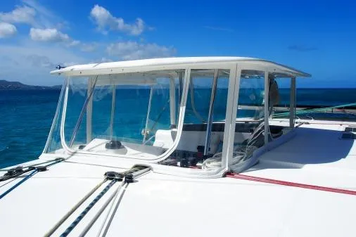Slide: The Image of Leopard 48 yacht, 2015 model, with clear canopy, sailing on blue ocean under sunny sky. - 48