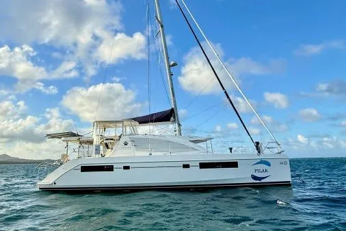 Slide: The Image of 2015 Leopard 48 catamaran sailing on open water under a partly cloudy sky. - 5