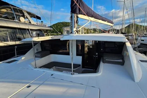 Slide: The Image of 2015 Leopard 48 yacht with spacious deck and seating area in marina. - 52