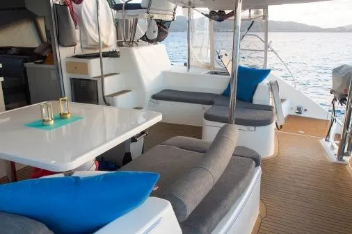 Slide: The Image of Luxurious 2015 Leopard 48 yacht interior with seating and dining area, overlooking the ocean. - 54