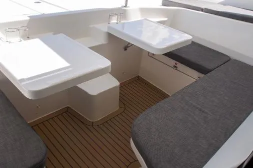 Slide: The Image of Interior of 2015 Leopard 48 yacht with cushioned seating and wooden flooring. - 56