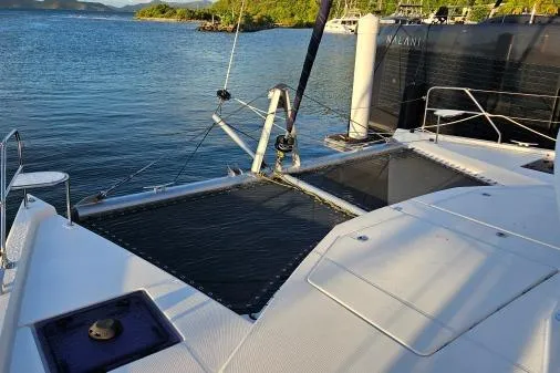 Slide: The Image of Leopard 48 catamaran deck, 2015 model, docked by serene waters. - 58