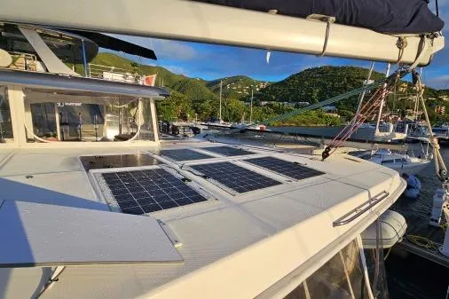Slide: The Image of Leopard 48 yacht with solar panels, docked in a scenic marina, 2015 model. - 60