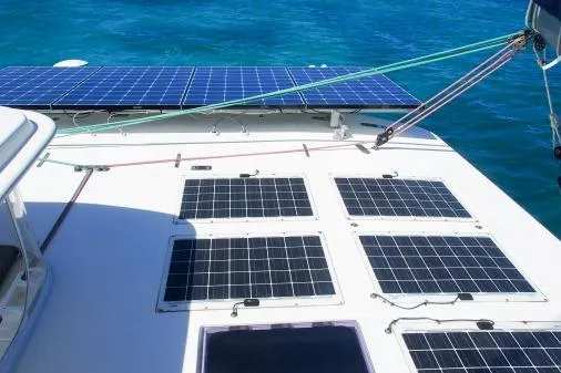 Slide: The Image of Solar panels on a 2015 Leopard 48 catamaran, harnessing energy on clear blue waters. - 61
