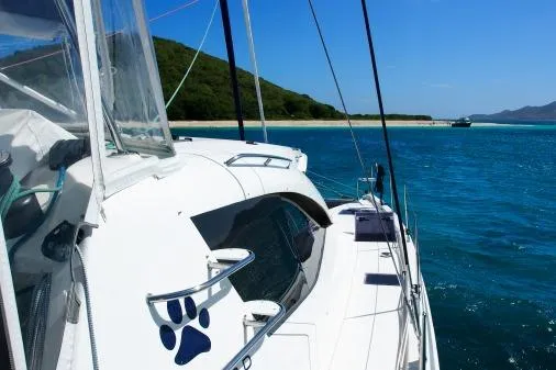 Slide: The Image of Sailing yacht Leopard 48, 2015 model, cruising in clear blue waters near a scenic coastline. - 64