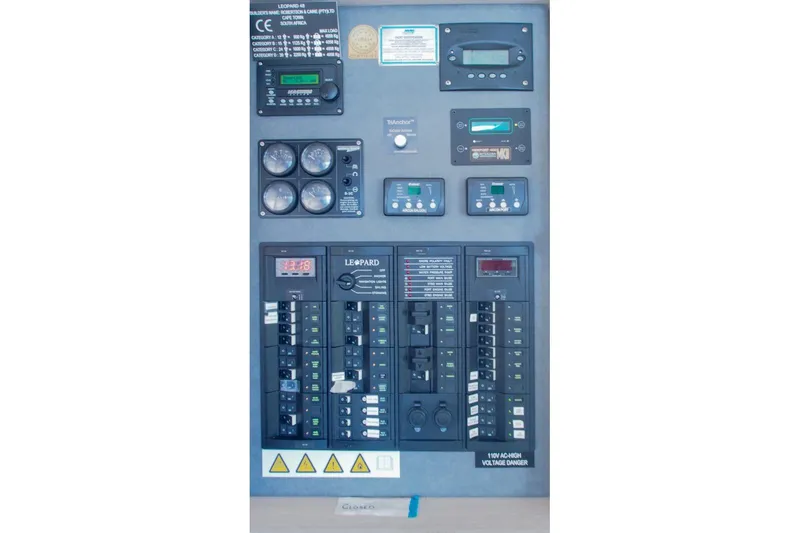 Slide: The Image of Electrical control panel of a 2015 Leopard 48 yacht with various gauges and switches. - 76