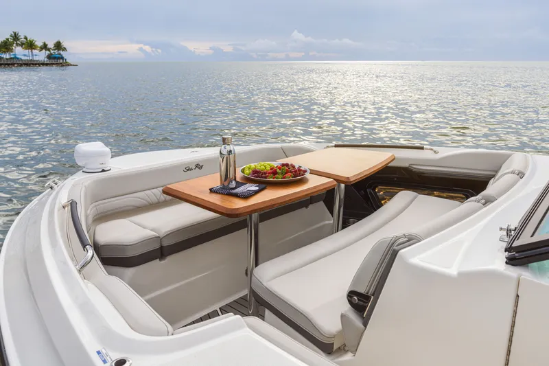 Slide: The Image of The 2026 Sea Ray SLX 360 Outboard features an elegant seating area with a table and ocean view. - 11
