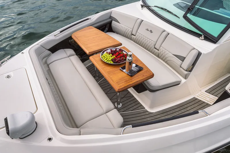 Slide: The Image of Luxurious seating area with wooden tables and fruit platter on a Sea Ray SLX 360 Outboard. - 12