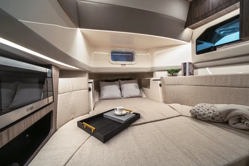 Slide: The Image of Interior of the 2026 Sea Ray SLX 360 Outboard with a cozy bed and modern design. - 19