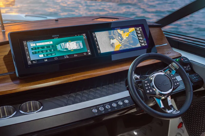 Slide: The Image of The image shows the modern cockpit of a Sea Ray SLX 360 Outboard with two large screens and a sleek steering wheel. - 5
