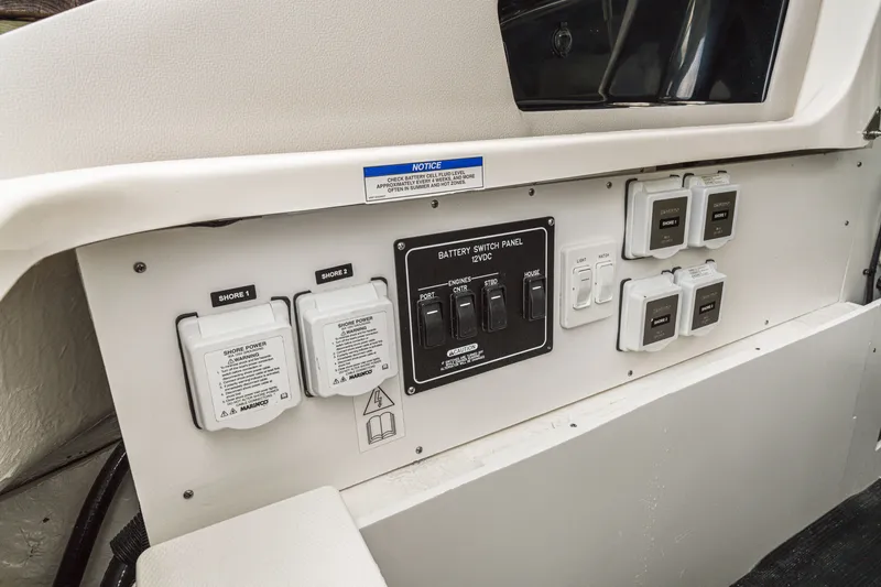 Slide: The Image of Control panel with multiple switches and outlets on a boat. - 13