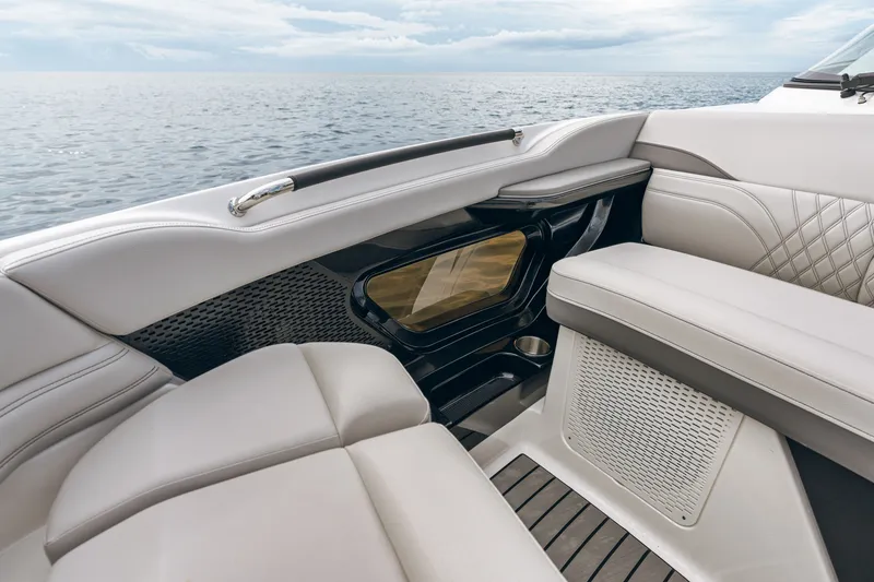 Slide: The Image of The 2026 Sea Ray SLX 360 Outboard features luxurious cushioned seating with a view of the sea. - 17