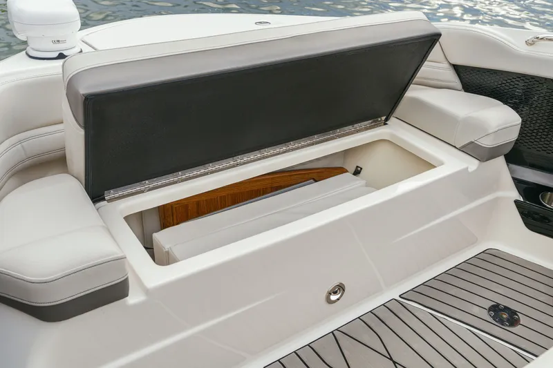 Slide: The Image of The 2026 Sea Ray SLX 360 Outboard features an open storage compartment with cushioned seating. - 26