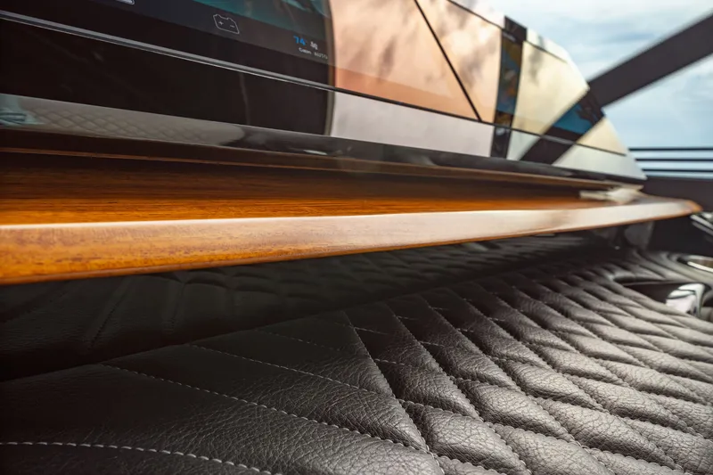 Slide: The Image of Close-up of a luxurious boat interior with quilted leather and wood trim. - 6