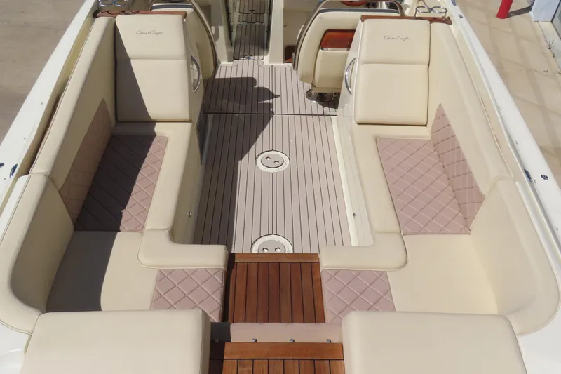 Slide: The Image of 2018 Chris Craft Launch 34 boat interior with beige seating and wooden flooring. - 16