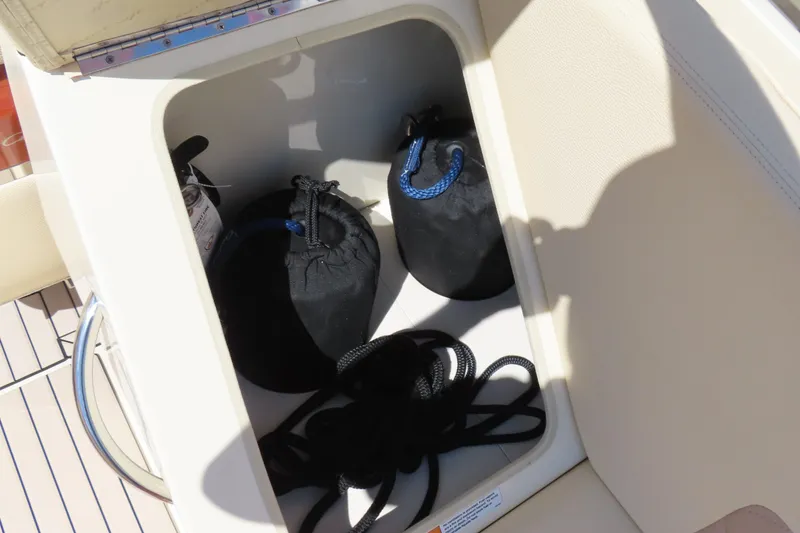 Slide: The Image of Storage compartment on 2018 Chris Craft Launch 34 boat with ropes and bags. - 18