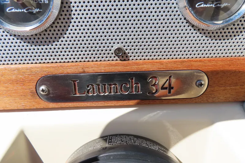 Slide: The Image of 2018 Chris Craft Launch 34 dashboard with wood and metal detailing. - 19