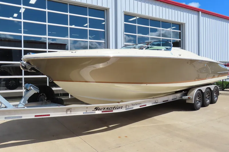 Slide: The Image of 2018 Chris Craft Launch 34 boat on trailer outside a modern building. - 2