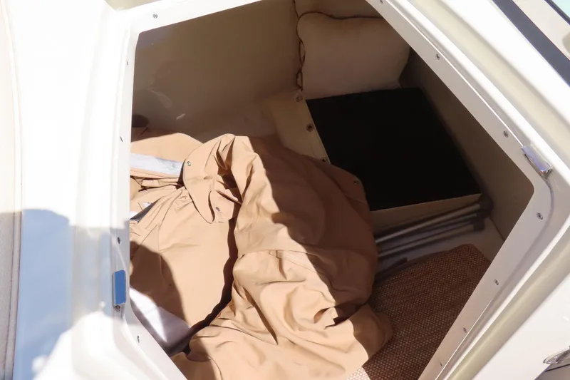 Slide: The Image of 2018 Chris Craft Launch 34 cabin interior with beige fabric and storage space. - 20