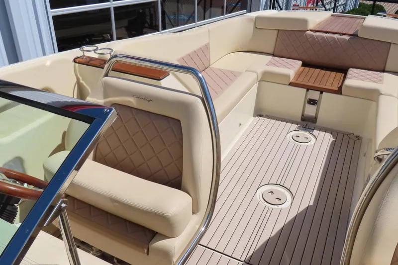 Slide: The Image of 2018 Chris Craft Launch 34 interior with beige seating and wooden accents. - 23
