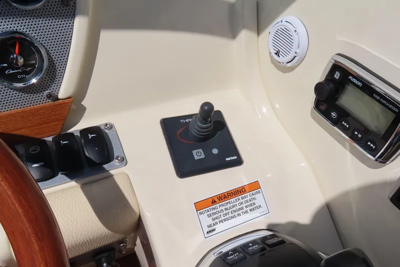 Slide: The Image of 2018 Chris Craft Launch 34 dashboard with controls, gauges, and warning label. - 29