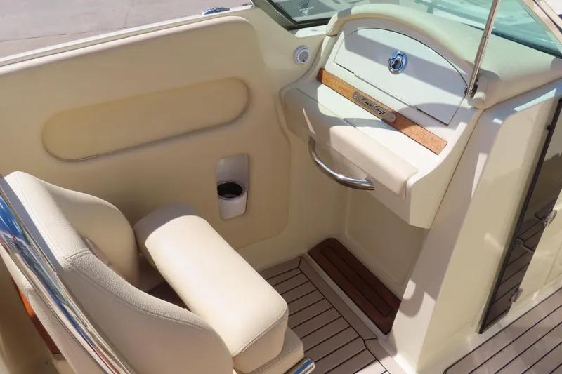 Slide: The Image of 2018 Chris Craft Launch 34 interior with beige seating and wood accents. - 35