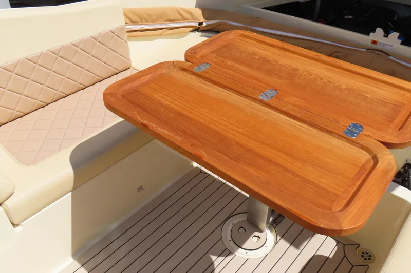 Slide: The Image of Luxurious interior of 2018 Chris Craft Launch 34 with wooden table and cushioned seating. - 36