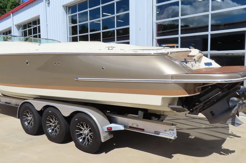 Slide: The Image of 2018 Chris Craft Launch 34 boat on trailer, parked outside a garage. - 9