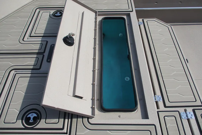 Slide: The Image of Open storage compartment on 2026 Avid 18 Commander boat deck. - 13