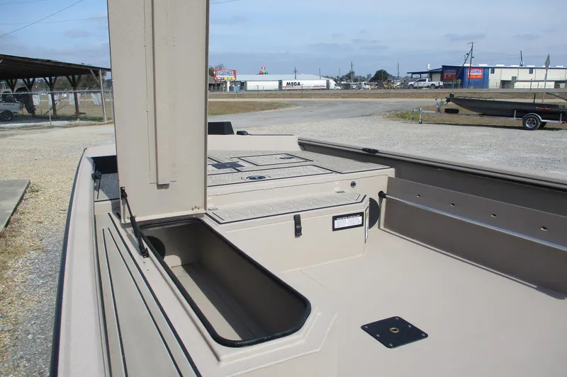 Slide: The Image of 2026 Avid 18 Commander boat interior with storage compartments and open deck. - 14