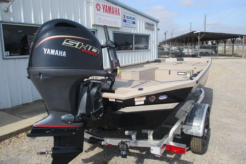 Slide: The Image of 2026 Avid 18 Commander boat with Yamaha VMAX outboard motor, parked outside dealership. - 2