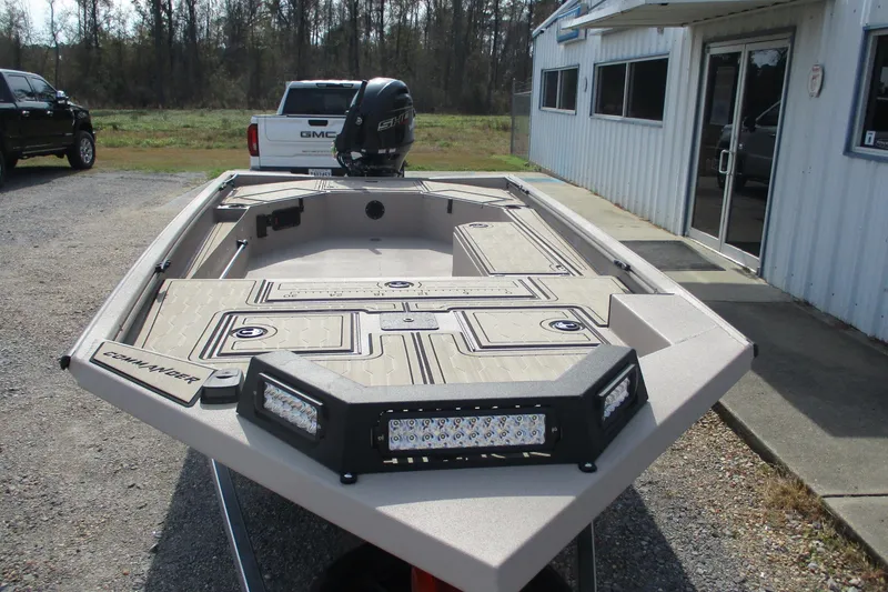 Slide: The Image of 2026 Avid 18 Commander boat with modern design, parked outside a building. - 3