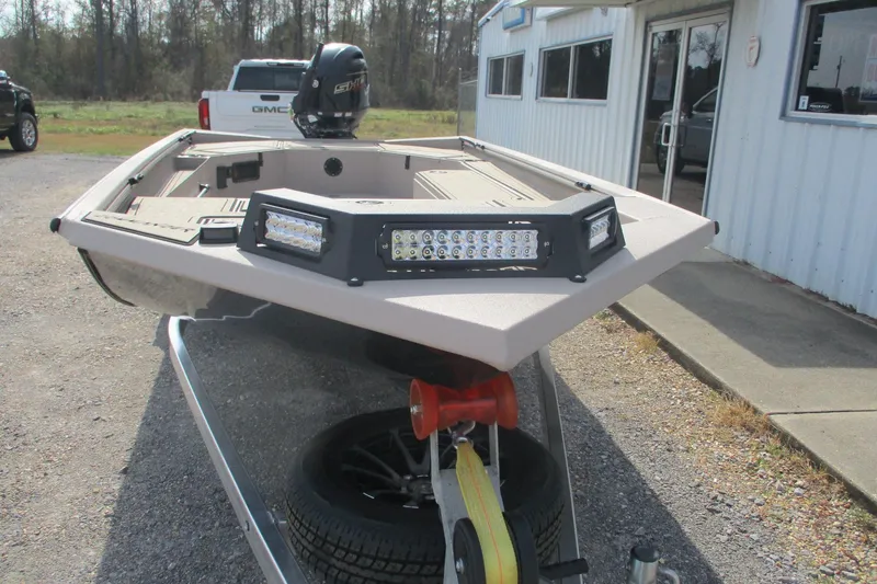 Slide: The Image of 2026 Avid 18 Commander boat with LED lights, parked outside a building. - 4