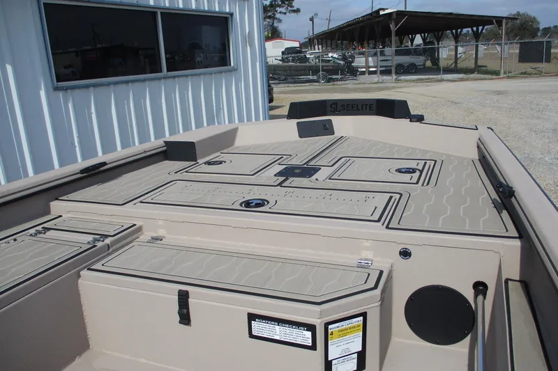 Slide: The Image of 2026 Avid 18 Commander boat deck with storage compartments and Seelite branding. - 6