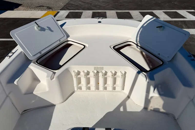 Slide: The Image of 2010 Carolina Skiff 192 DLV boat deck with open storage compartments. - 10