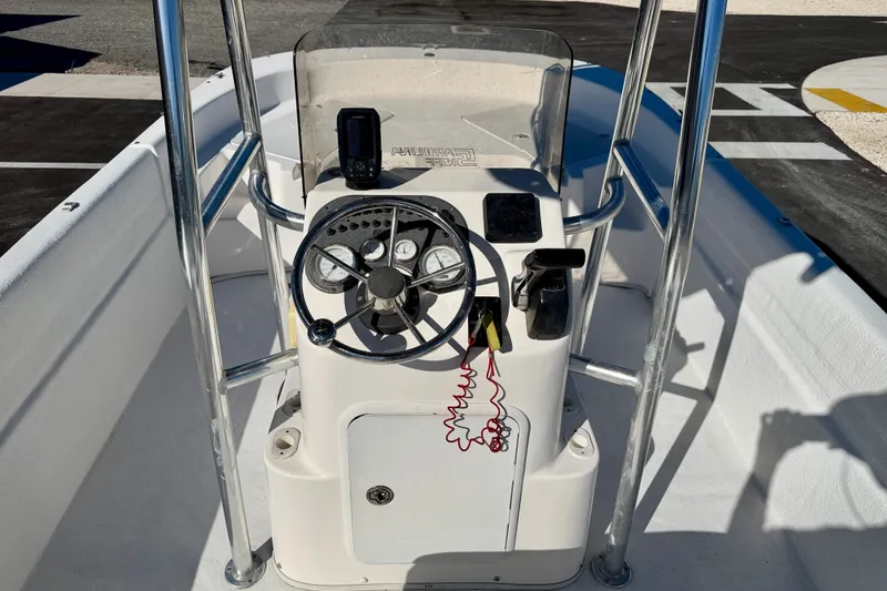 Slide: The Image of 2010 Carolina Skiff 192 DLV boat console with steering wheel and controls. - 12