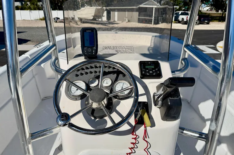 Slide: The Image of 2010 Carolina Skiff 192 DLV boat console with steering wheel and navigation equipment. - 13