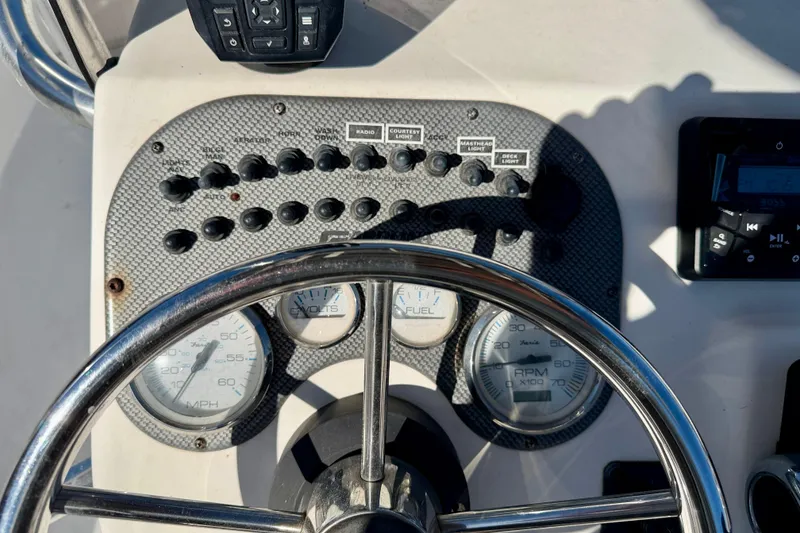 Slide: The Image of Dashboard of a 2010 Carolina Skiff 192 DLV boat with steering wheel and gauges. - 14