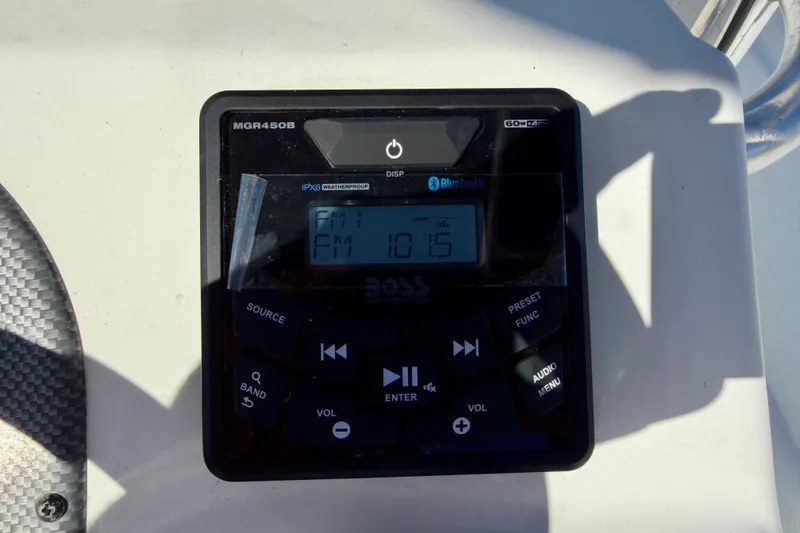 Slide: The Image of Boat stereo system on a 2010 Carolina Skiff 192 DLV, displaying FM 101.5. - 16