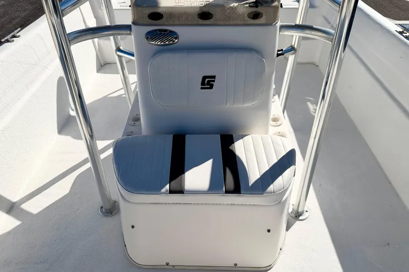 Slide: The Image of 2010 Carolina Skiff 192 DLV boat interior with white seating and metal railings. - 18