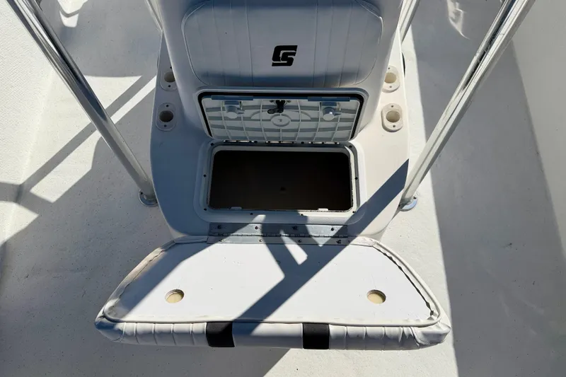 Slide: The Image of 2010 Carolina Skiff 192 DLV boat storage compartment with open hatch and seating. - 19